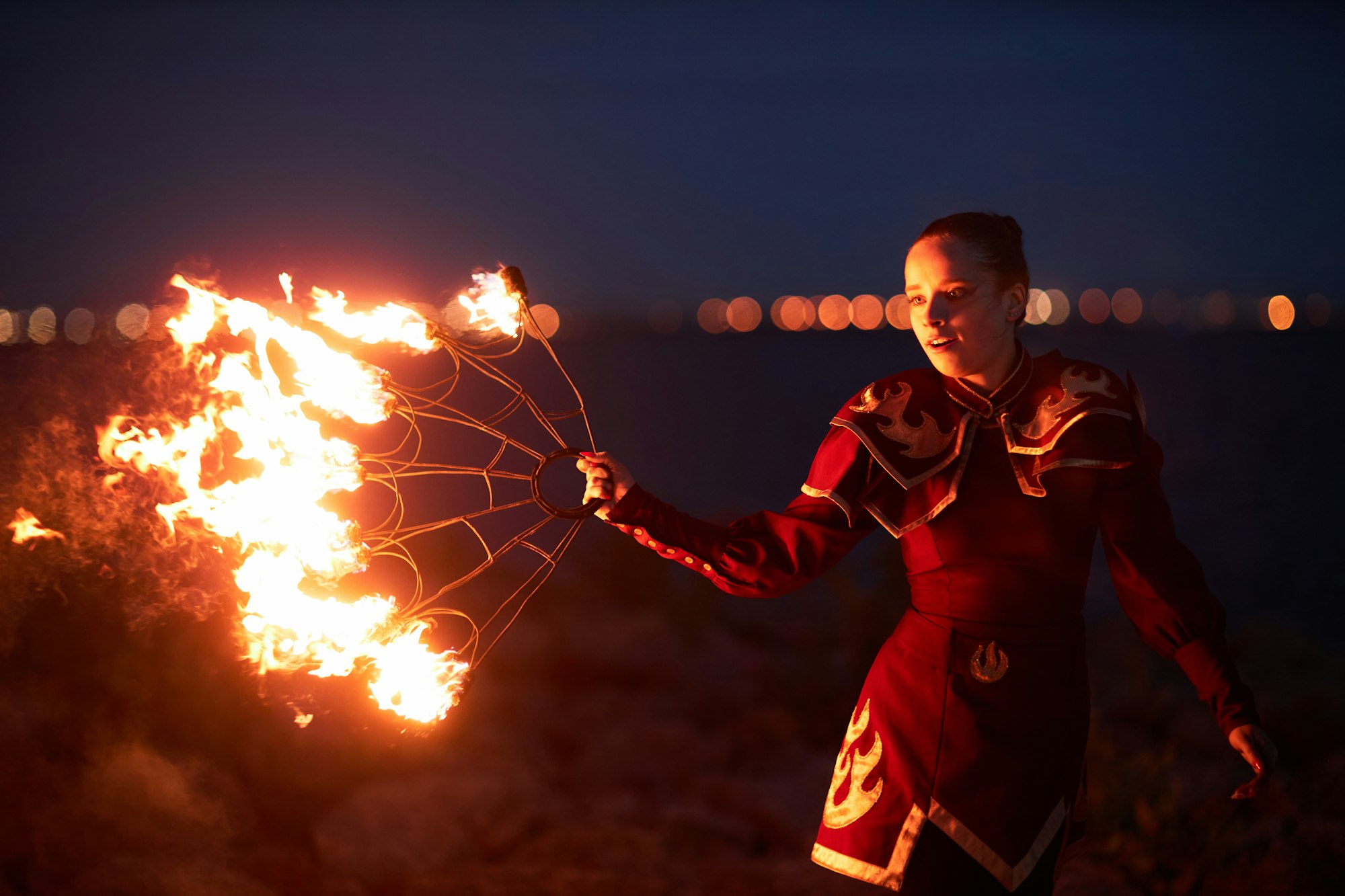 Female performer dancing with fire fans